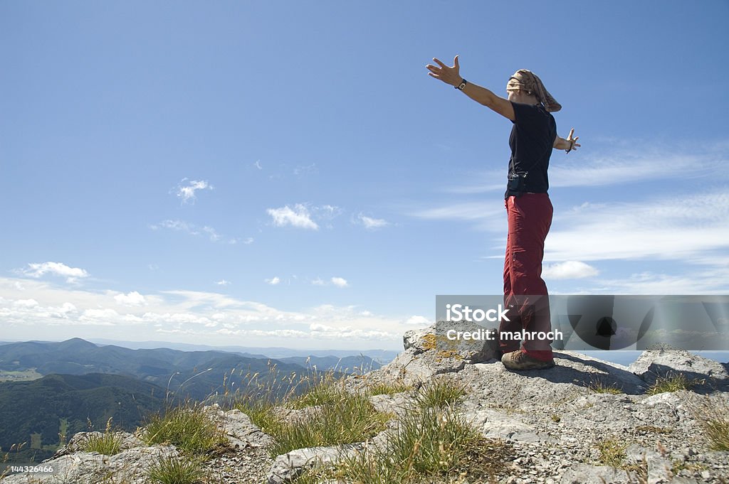 At the top Female tourist at the top of mountain with big valley under her Achievement Stock Photo