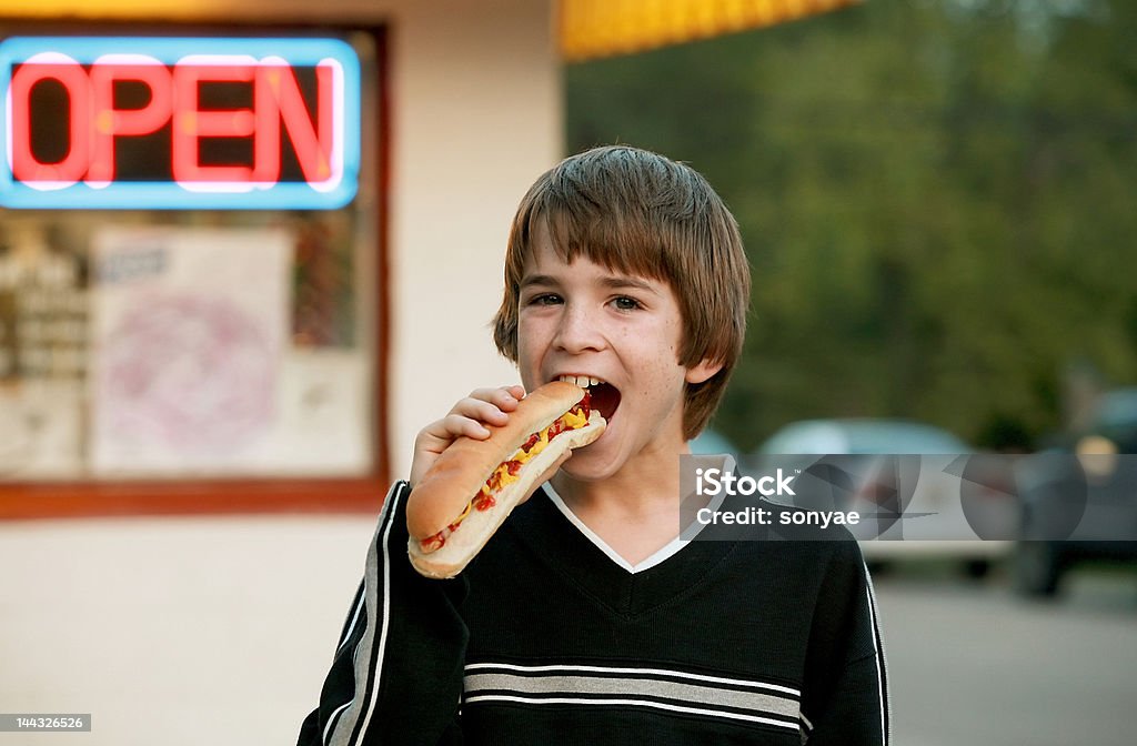 Ragazzo mangia un Hot Dog Footlong - Foto stock royalty-free di Hot Dog