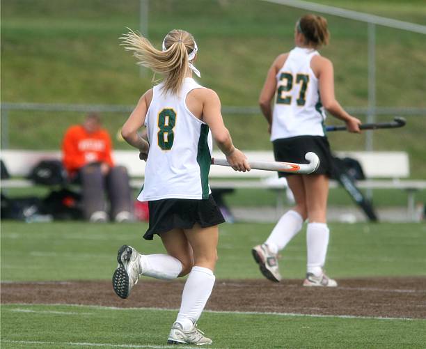 istock Females playing a game field hockey 144326672