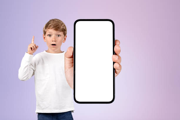 istock Child finger pointing up, phone mockup display on gradient background 1443266838