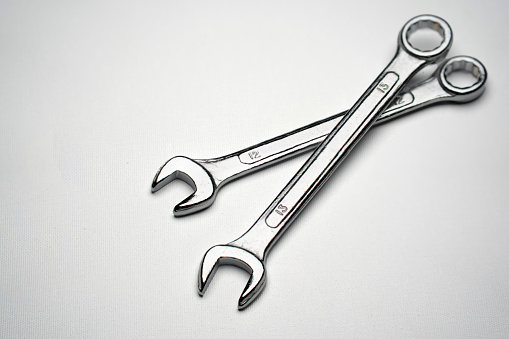 Two sizes of open-ended wrenches isolated on white Mechanic tools such as construction work, garages and other mechanic work