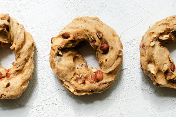 Tarallas with roasted almonds on a white background. Delicious Neapolitan pastries. Traditional Italian snacks. Top view. Close up. Horizontal orientation. stock photo