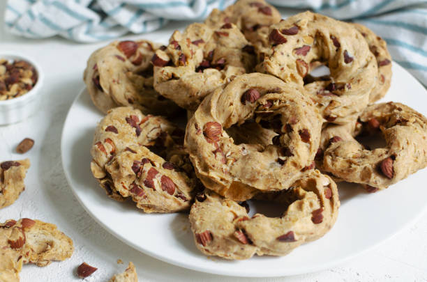istock Tarallas with roasted almonds on a white plate on a white background. Delicious Neapolitan pastries. Traditional Italian snacks. Horizontal orientation. 1443268961