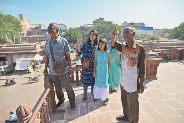 Senior man guide explaining to multi-generation tourist, Jodhpur, Rajasthan