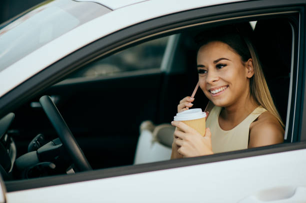 istock Young woman using phone in the car 1443270031