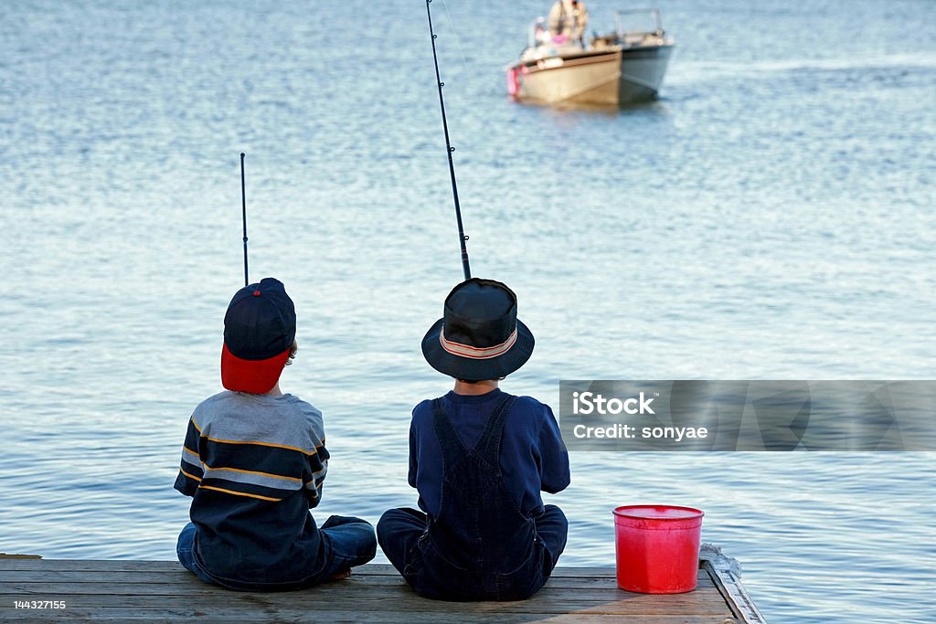 Boys Fishing Two Boys Fishing at the End of Pier Fishing Stock Photo