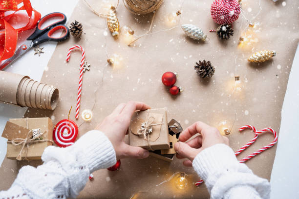 istock Key to house with keychain on cozy home in gift box with Christmas decor packaging. Pack present for New Year, Christmas. Building, project, moving to new house, mortgage, rent, purchase real estate 1443272099