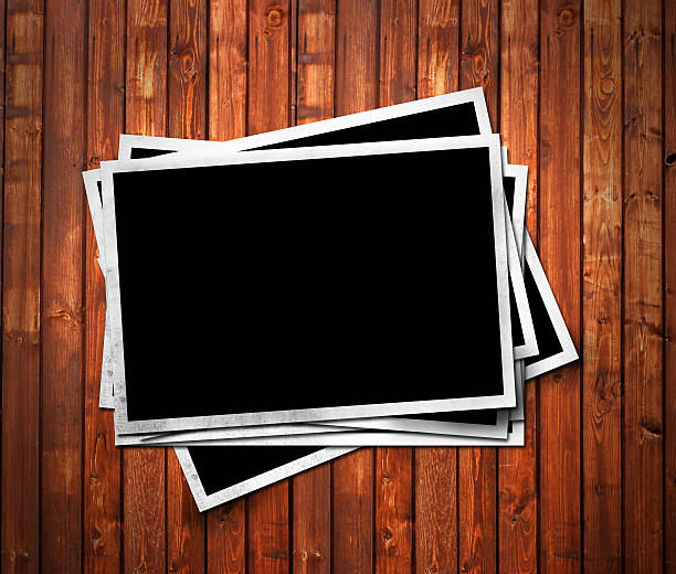 istock Aged photo frames on wood background 144327312