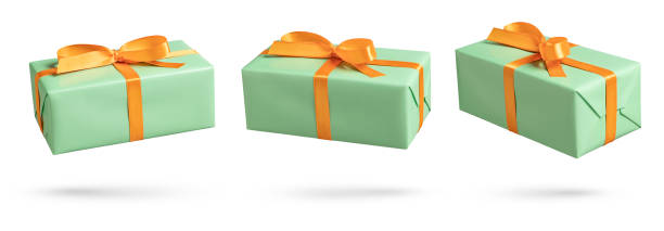 istock Set of green gift boxes with orange ribbon on white 1443275830
