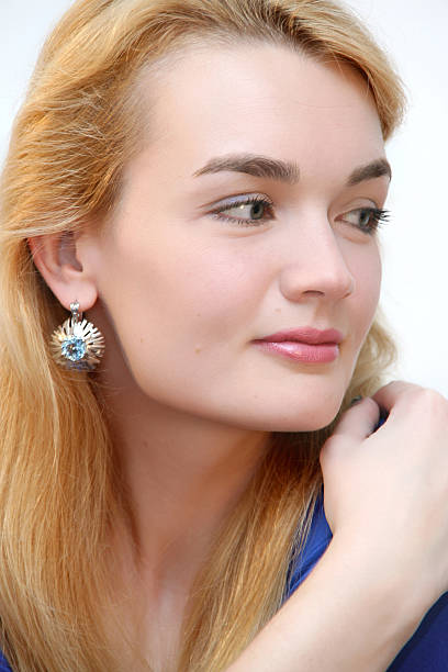 attractive blonde and silver earrings stock photo