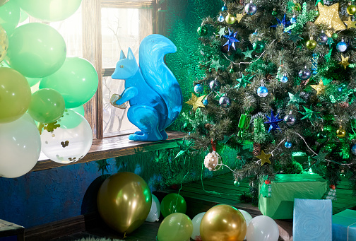 Christmas themed interiors in loft apartment, with Christmas tree, green and blue colors design, studio shot