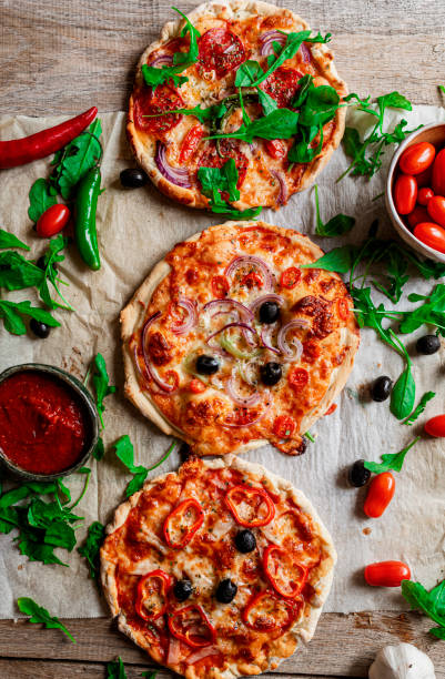 istock Rustic homemade pizza on wooden base 1443278113