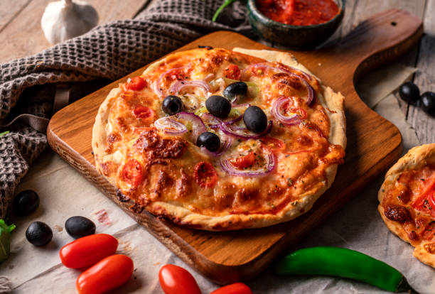 istock Rustic homemade pizza on wooden base 1443278142