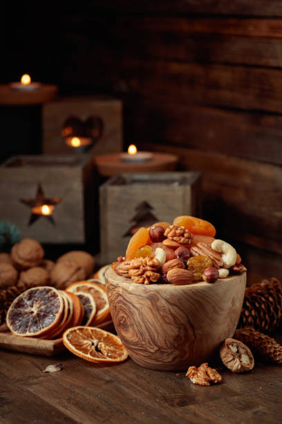 istock Dried fruits and assorted nuts on a wooden table. 1443280077