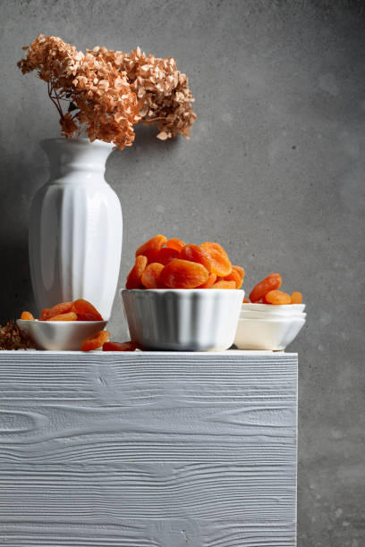 Dried apricots on a white wooden table.