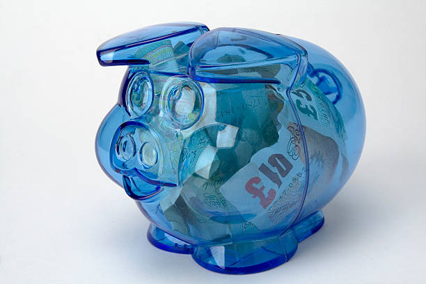 Piggy bank with pound notes money stock photo