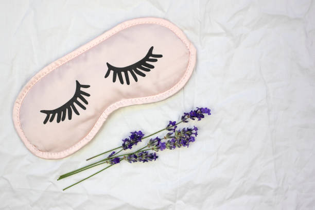 istock Sleep mask with natural lavender on a white sheet. 1443283163
