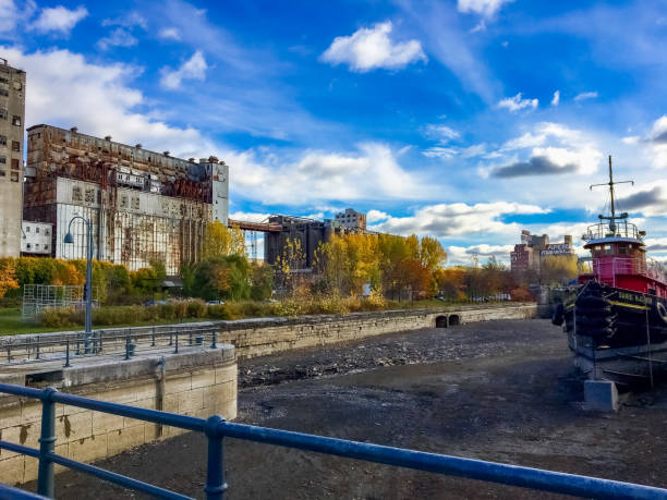 Montreal, Canada - November 2016: Abandoned Silo #5 and a boat in the Old Port of Montreal. It's been abandoned since 1996. The Federal Heritage Buildings Review Office has recognised it's special status, for being the last example of the evolution of grain elevators in the 20th century.