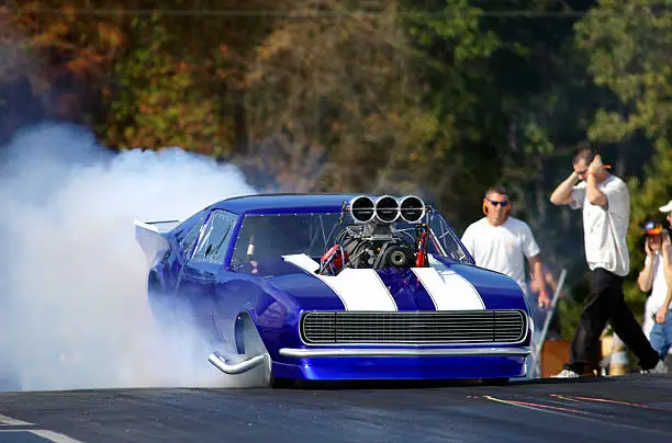 race car reving it up and burning rubber at the dragstrip