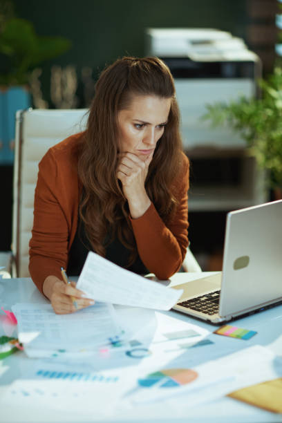 istock business owner woman in green office working with documents 1443284755
