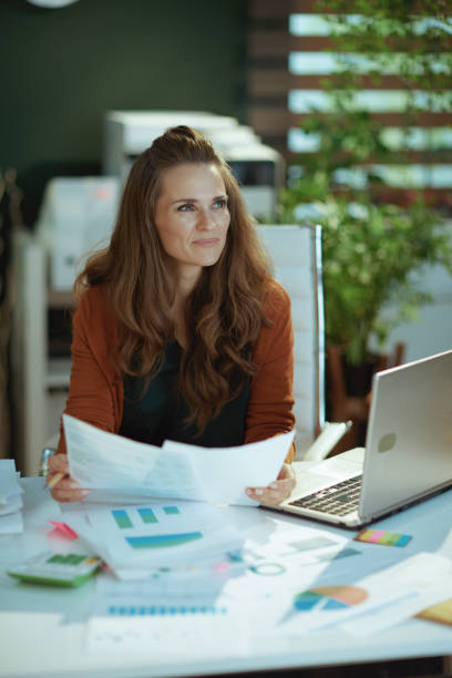 istock business owner woman in green office working with documents 1443284761