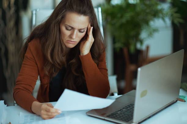 istock business owner woman in green office working with documents 1443284766