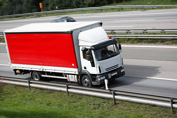 istock red and white european truck on multi lane highway 144328526