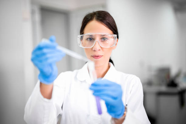 istock Female technician in a laboratory working with a pipette during an experiment 1443286690
