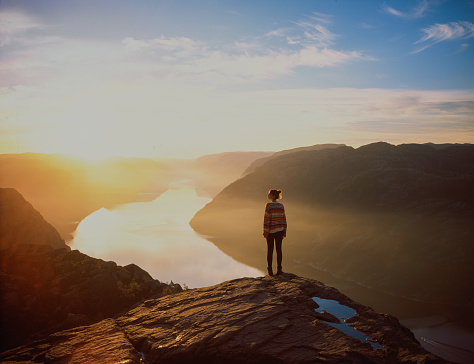 Woman hiking in mountains on the background of Lysefjorden