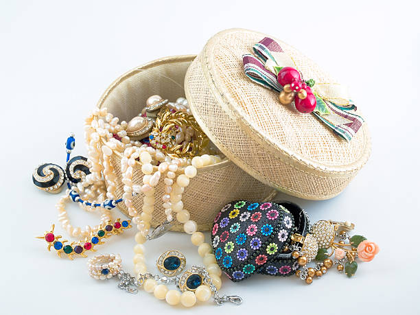 Accessories A girl's jewelry and accessories box overflowing with necklaces, brooches, earrings, and other knick knacks. costume jewelry stock pictures, royalty-free photos & images