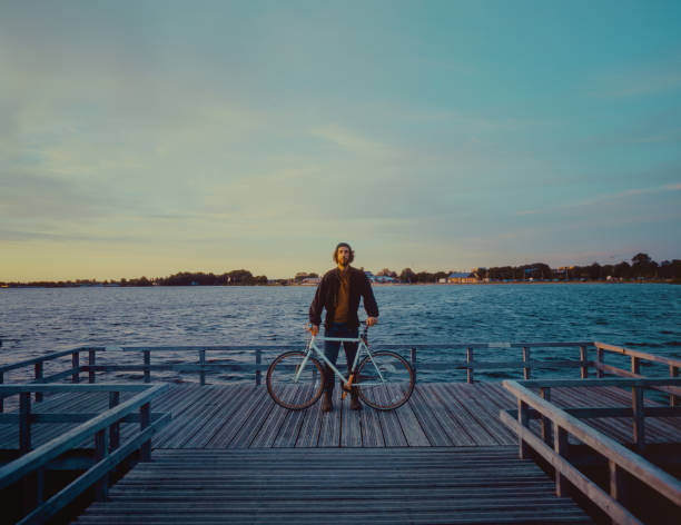 istock Man with bicycle near the lake 1443287779