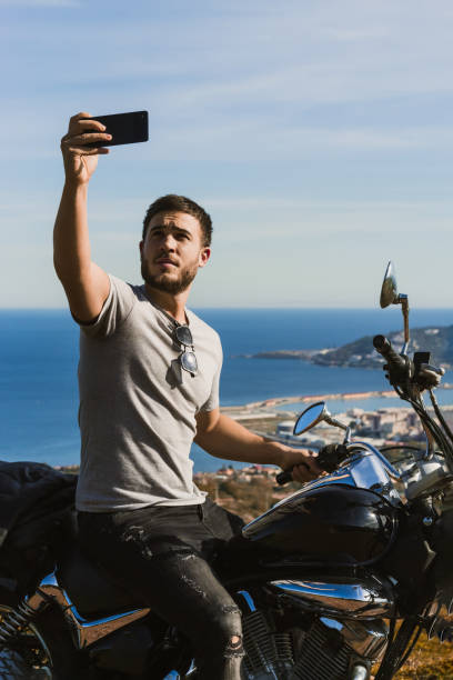 istock Biker taking a selfie with the landscape during a route 1443289709