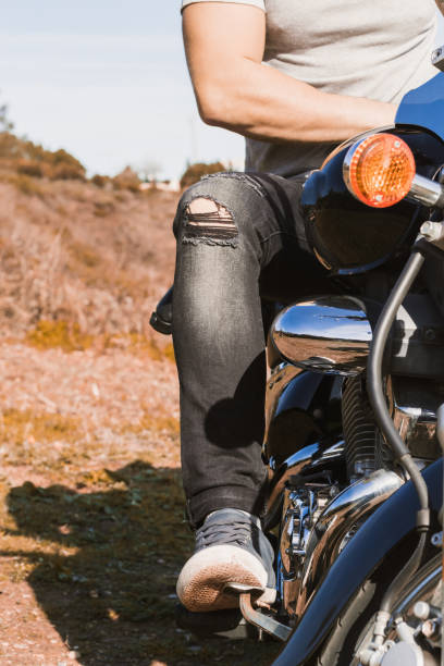 istock Vertical partial view of young biker riding a custom motorcycle 1443289798