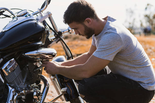 istock Crouching biker worried about a motorcycle breakdown 1443289816