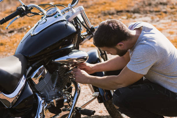 istock Crouching biker worried about a motorcycle breakdown 1443289835