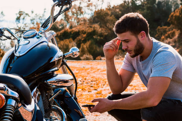 istock Crouching biker worried about a motorcycle breakdown 1443289888