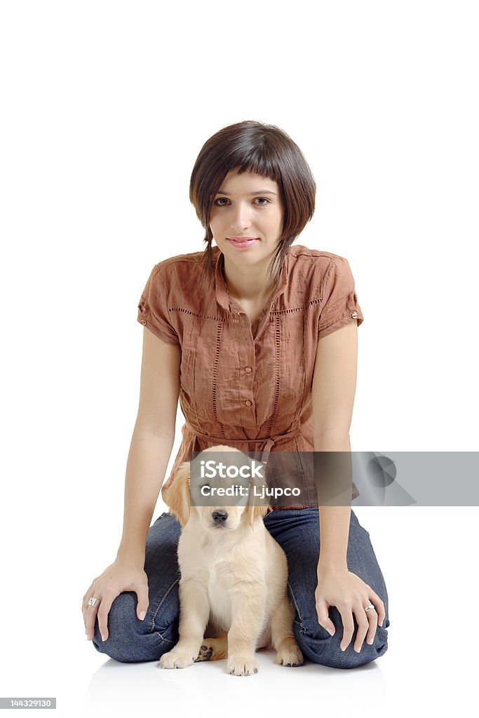 Dziewczyna i golden retriever szczeniak - Zbiór zdjęć royalty-free (Labrador Retriever)