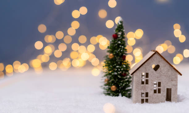 istock Christmas tree and house  in the snow 1443291610