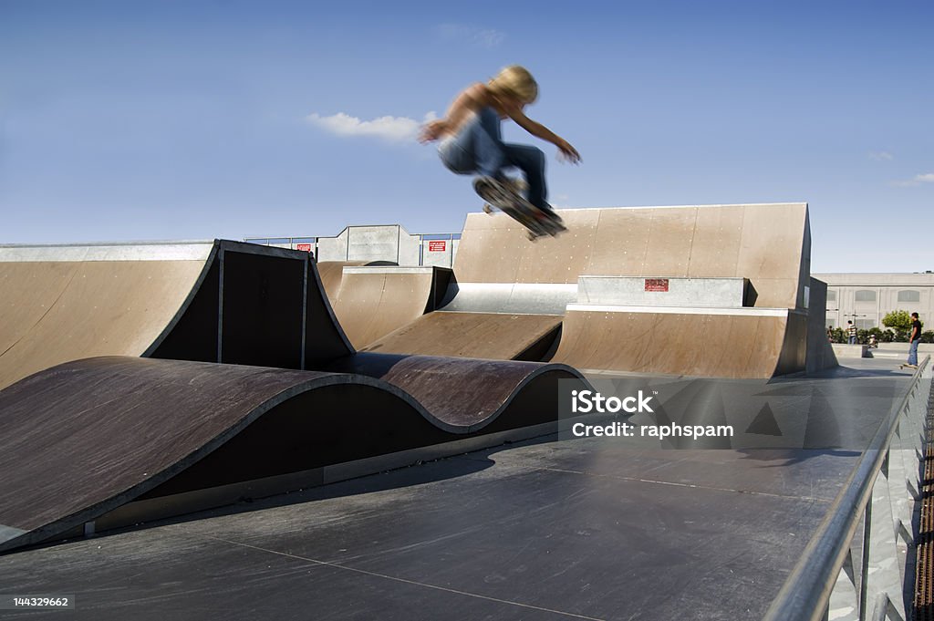Skater Skater doing a big air ollie in a skate park Big Air Stock Photo