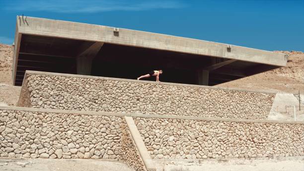 istock Woman does sports training on a stone build structure on a hot sunny day 1443296922