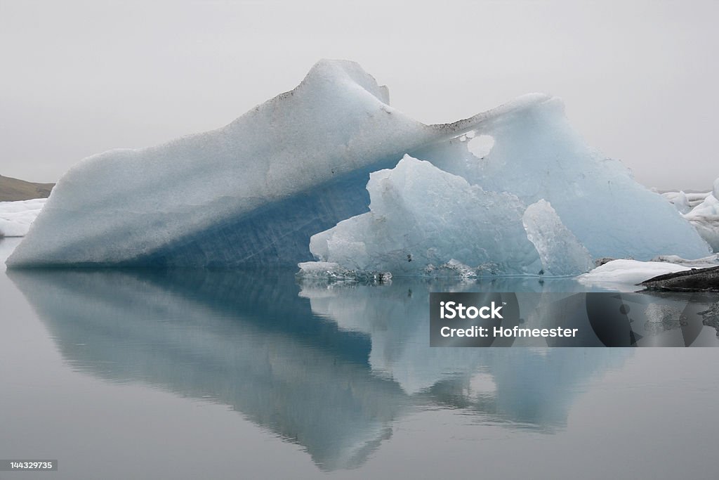 Blue icebergs Two blue icebergs at glacier lake in Iceland with reflection in water Arctic Stock Photo