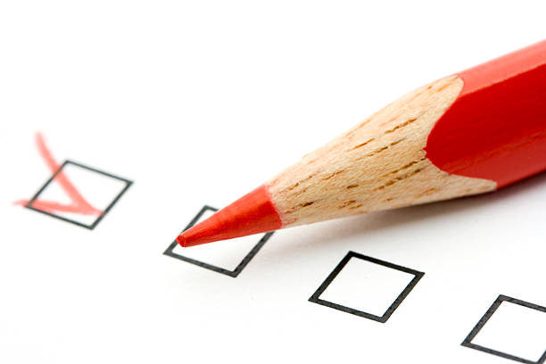 istock Red pencil filling in check boxes 144329798