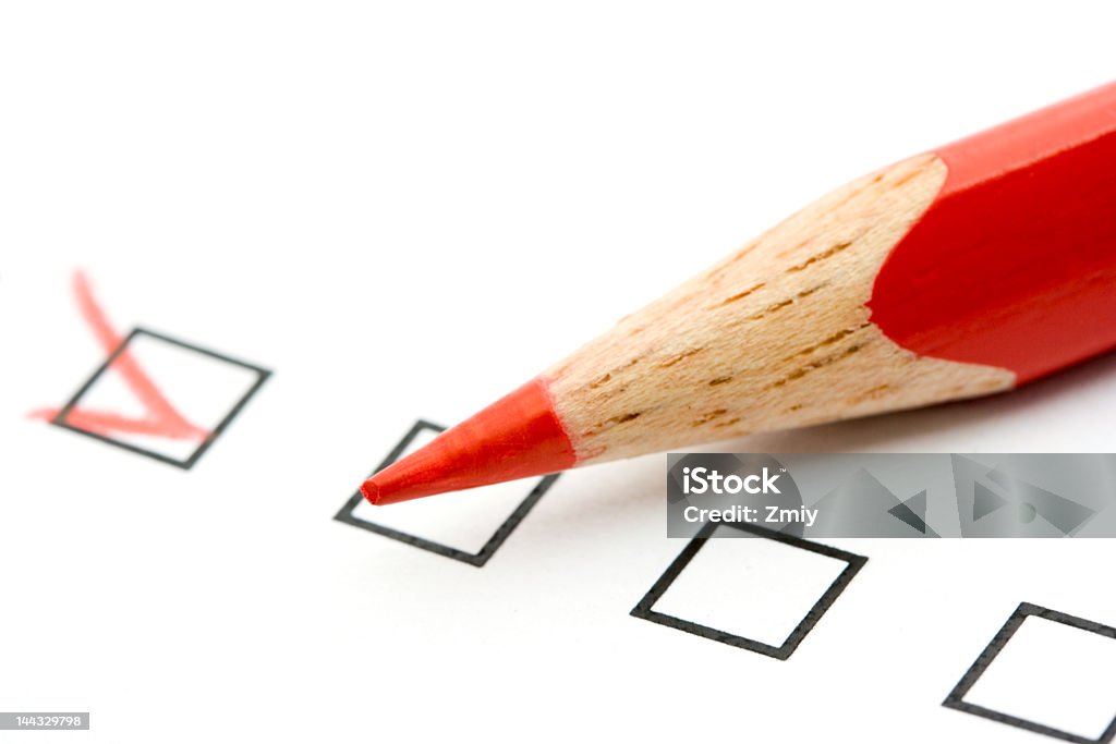 Red pencil filling in check boxes Red pencil and questionnaire Check Mark Stock Photo