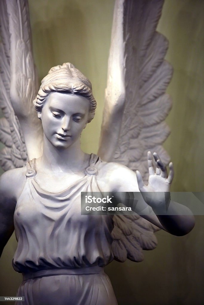 Angel Statue of a sad angel from a stone Adult Stock Photo