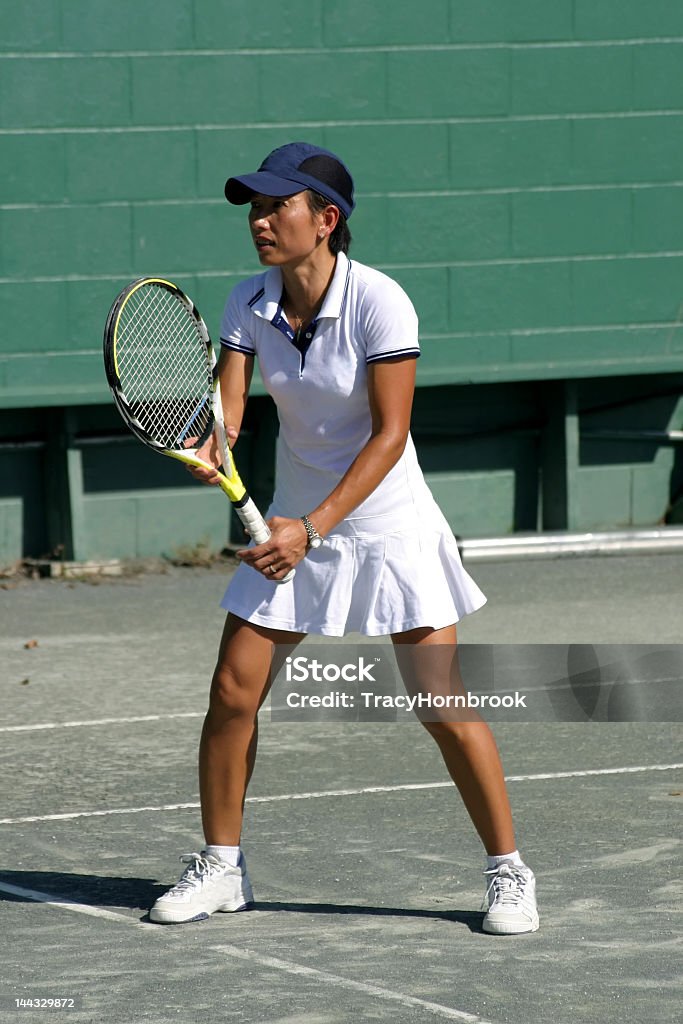 ethnic female tennis player waiting for serve Active Lifestyle Stock Photo