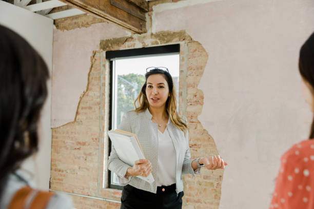 istock Female real estate agent assesses businesswomen's office space needs 1443298748