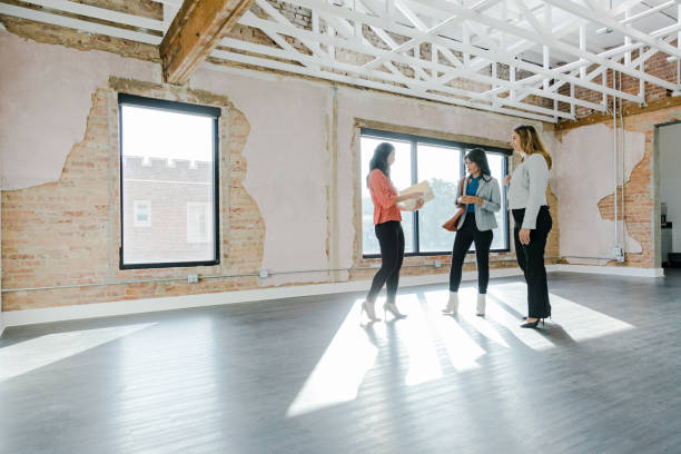 istock Female Real Estate Agent pulls out rental documents for businesswomen 1443298774