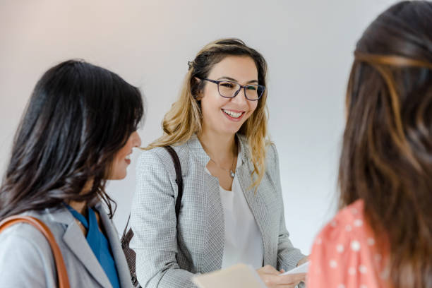 istock Three businesswomen smile during impromptu meeting 1443298780