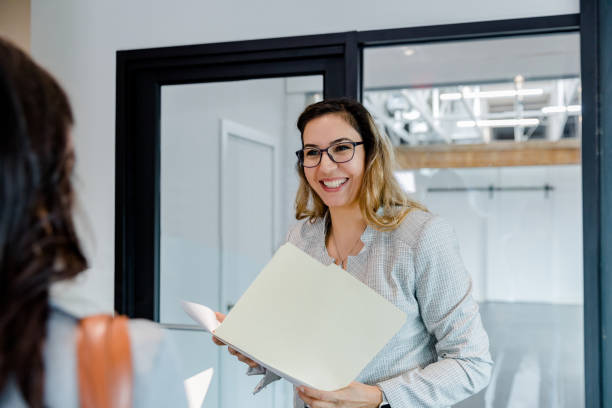 istock Real Estate Agent smiles while discussing rental documents with unrecognizable client 1443298789