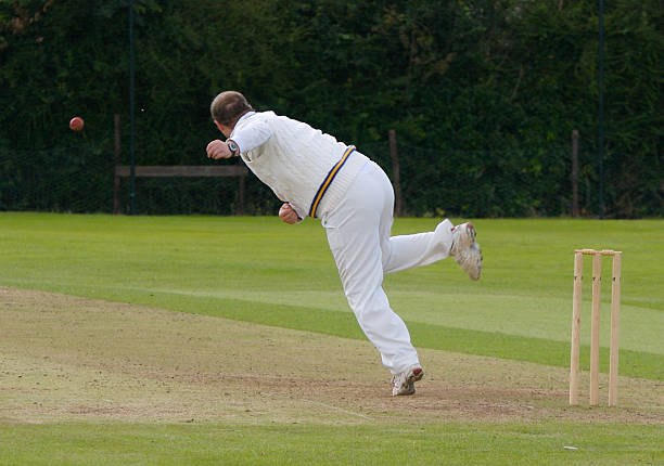 istock A bowler bowling on a green cricket field 144329974